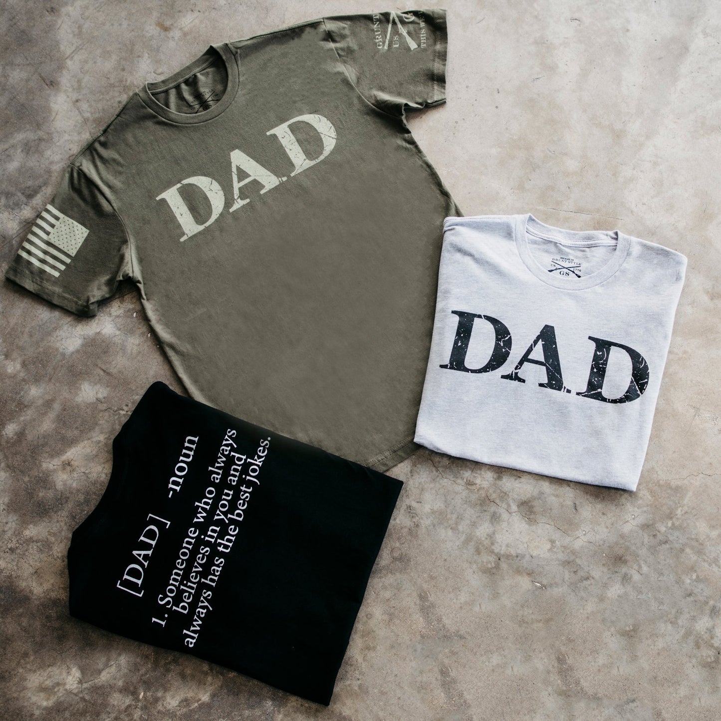 the green, grey, and black short sleeve graphic tees grouping of what is offered with the Dad Defined graphic logo